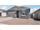 Charming single-story home featuring a two-car garage, neutral color scheme, and well-maintained gravel landscaping at 18256 W La Senda Dr, Surprise, AZ 85387