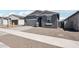 Charming single-Gathering home with a two-car garage, desert landscaping, and a paved walkway leading to the entrance at 18256 W La Senda Dr, Surprise, AZ 85387