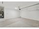 Clean garage with concrete flooring, water heater, and white walls, providing a versatile space at 18256 W La Senda Dr, Surprise, AZ 85387