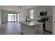 Modern kitchen with an island, stainless steel appliances, and a view of the backyard through sliding glass doors at 18256 W La Senda Dr, Surprise, AZ 85387
