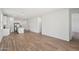 Open-concept living area features wood-look flooring that flows into the modern kitchen at 18256 W La Senda Dr, Surprise, AZ 85387