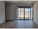 Living room with tile flooring and large sliding glass doors leading to an outdoor space at 18256 W La Senda Dr, Surprise, AZ 85387