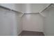 Spacious walk-in closet with ample shelving and hanging space, ready for organization and storage at 18256 W La Senda Dr, Surprise, AZ 85387