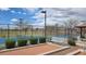 Community tennis and bocce ball courts under a partly cloudy sky, surrounded by greenery and benches at 18261 W Camino De Oro --, Surprise, AZ 85387
