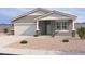 Charming single-story home featuring a two-car garage, desert landscaping, and neutral stucco exterior at 18272 W Camino De Oro --, Surprise, AZ 85387
