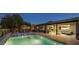 Expansive backyard features a modern pool with a baja shelf, patio seating, and seamless flow to the indoor living spaces at 20 W Canterbury Ln, Phoenix, AZ 85023