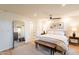Bright bedroom with a plush bed, bench, and stylish decor at 20 W Canterbury Ln, Phoenix, AZ 85023