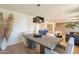 Sunlit dining room featuring a stylish chandelier and wood table at 20 W Canterbury Ln, Phoenix, AZ 85023