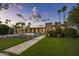 Charming exterior view of home with manicured lawn, mature landscaping, and a long driveway leading to a two-car garage at 20 W Canterbury Ln, Phoenix, AZ 85023