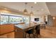 Open-concept kitchen featuring a large island, modern appliances, and a seamless flow to the dining area at 20 W Canterbury Ln, Phoenix, AZ 85023