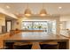 Spacious kitchen island with modern pendant lighting and a view of the bright backyard at 20 W Canterbury Ln, Phoenix, AZ 85023