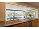 Well-lit kitchen with a view of the backyard pool, ample counter space, and modern appliances at 20 W Canterbury Ln, Phoenix, AZ 85023