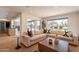 Bright living room with an open floor plan, hardwood floors, and a large sectional sofa by the windows at 20 W Canterbury Ln, Phoenix, AZ 85023