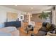 Open-concept living room with neutral tones, chic furnishings, and decorative brick accent wall at 20 W Canterbury Ln, Phoenix, AZ 85023