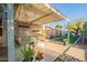 Relaxing outdoor patio area with comfortable seating, shade, decorative plants, and an artificial turf area at 20 W Canterbury Ln, Phoenix, AZ 85023