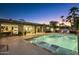 Stunning outdoor living space with a pool featuring a baja shelf and waterfall, all within view of the home's modern interior at 20 W Canterbury Ln, Phoenix, AZ 85023
