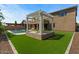 A backyard with a swimming pool, lounge seating, pergola, outdoor dining area, and turf at 20483 E Mockingbird Dr, Queen Creek, AZ 85142