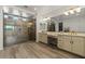 Spa-like bathroom features a large tiled glass shower, double sink vanity, and wood-look floors at 20483 E Mockingbird Dr, Queen Creek, AZ 85142