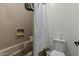 Clean bathroom features a shower-tub combo, white shower curtain, and basic amenities at 20483 E Mockingbird Dr, Queen Creek, AZ 85142