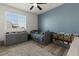 Well-organized bedroom features a daybed, storage, a feature wall, and a large window at 20483 E Mockingbird Dr, Queen Creek, AZ 85142