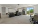 Large bonus room with projector screen, comfortable seating, and access to outdoor balcony at 20483 E Mockingbird Dr, Queen Creek, AZ 85142
