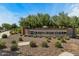Welcome to Fulton Homes Queen Creek Station; picturesque community entrance with manicured landscaping and decorative brick signage at 20483 E Mockingbird Dr, Queen Creek, AZ 85142