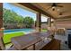 Spacious covered patio with outdoor dining furniture, ceiling fans, and backyard views at 20483 E Mockingbird Dr, Queen Creek, AZ 85142