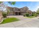 Charming two-story home with a well-manicured lawn, mature trees, and a three-car garage and a beautiful architectural style at 20483 E Mockingbird Dr, Queen Creek, AZ 85142