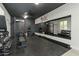 Spacious home gym featuring workout equipment, rubber flooring, mirrors, and a ceiling fan at 20483 E Mockingbird Dr, Queen Creek, AZ 85142