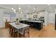An open-concept kitchen and dining area with an island, stainless appliances, stylish lighting, and ample seating at 20483 E Mockingbird Dr, Queen Creek, AZ 85142