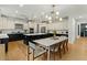 A modern, well-lit kitchen features black and white cabinetry, stainless steel appliances, and a large central island with pendant lighting at 20483 E Mockingbird Dr, Queen Creek, AZ 85142