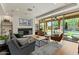 A spacious living room with a fireplace, built-in shelving, and sliding glass doors to the outdoor living area at 20483 E Mockingbird Dr, Queen Creek, AZ 85142