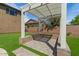 Backyard pergola with stone accents and pavers surrounded by lush artificial grass at 20483 E Mockingbird Dr, Queen Creek, AZ 85142