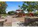 Community playground with slides, climbing structures, and shaded seating areas, providing a fun and safe environment for children at 20483 E Mockingbird Dr, Queen Creek, AZ 85142