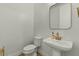 Modern powder room featuring a pedestal sink, modern faucet, and neutral decor at 20483 E Mockingbird Dr, Queen Creek, AZ 85142