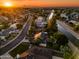 Gorgeous aerial view of a residential area highlighting well-maintained homes, lush landscaping, and a tranquil canal at golden hour at 2066 E Lockwood St, Mesa, AZ 85213