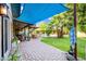 Charming covered patio with ample seating, complemented by a manicured lawn and inviting outdoor dining area with shade umbrellas at 2066 E Lockwood St, Mesa, AZ 85213