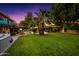 Lush backyard with a pool, patio, and string lights, creating an enchanting outdoor living space at 2066 E Lockwood St, Mesa, AZ 85213