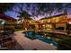 Inviting backyard with a pool, palm trees, patio furniture, and string lights for relaxing evenings at 2066 E Lockwood St, Mesa, AZ 85213