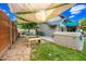 Private backyard with a covered patio, hot tub, lush landscaping, and vegetable gardens, perfect for outdoor entertaining and relaxation at 2066 E Lockwood St, Mesa, AZ 85213