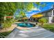 Serene backyard with a pool, lush greenery, and comfortable hammock, perfect for relaxation at 2066 E Lockwood St, Mesa, AZ 85213