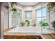 Bright bathroom with a large soaking tub surrounded by windows, natural light and privacy at 2066 E Lockwood St, Mesa, AZ 85213