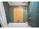 Close up of a shower/tub combination with a white shower curtain and blue tiled walls at 2066 E Lockwood St, Mesa, AZ 85213