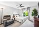 Bright bedroom with a queen size bed, ceiling fan and a sliding glass door to the outside at 2066 E Lockwood St, Mesa, AZ 85213