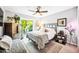 Bedroom featuring a queen bed, ceiling fan, a chest of drawers and a sliding glass door to the outside at 2066 E Lockwood St, Mesa, AZ 85213