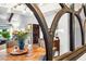 Cozy dining room features a round wood table with seating for four, a modern chandelier, and views to front entry at 2066 E Lockwood St, Mesa, AZ 85213