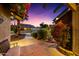 Charming exterior view of a home with a lush green front yard, desert landscaping, and blooming bougainvillea at 2066 E Lockwood St, Mesa, AZ 85213