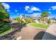 Charming single-story home featuring a well-manicured lawn, desert landscaping, and solar panels at 2066 E Lockwood St, Mesa, AZ 85213