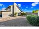 Charming home exterior with a private backyard, mature trees, and gravel landscaping, offering a serene and low-maintenance outdoor space at 2066 E Lockwood St, Mesa, AZ 85213