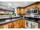Close up view of wood cabinets and granite countertops, stainless steel appliances, with view to backyard at 2066 E Lockwood St, Mesa, AZ 85213